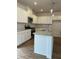 Bright kitchen features white cabinets, stainless steel appliances, granite countertops, and an island at 202 Groveton Ct, Euharlee, GA 30145