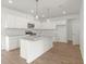 Modern kitchen features an island with a sink and granite countertops and a stainless steel appliance package at 202 Groveton Ct, Euharlee, GA 30145