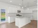 Bright kitchen features white cabinets, stainless steel appliances, and granite countertops at 202 Groveton Ct, Euharlee, GA 30145