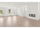 Bright open-concept living room boasts wood-style floors, recessed lighting, and a modern fireplace at 202 Groveton Ct, Euharlee, GA 30145