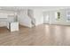 Inviting living area connects to the kitchen, featuring wood-style flooring and abundant natural light at 202 Groveton Ct, Euharlee, GA 30145