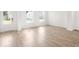 Bright living room features an entrance door, light hardwood floors, and white trim at 202 Groveton Ct, Euharlee, GA 30145