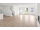 Bright, expansive living area featuring wood-style flooring, staircase, and plenty of natural light at 202 Groveton Ct, Euharlee, GA 30145