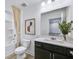 Clean bathroom features a tub with shower, neutral countertops, decorative mirror, and wood look floors at 3166 Morris Hills Dr, Dacula, GA 30019
