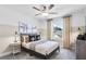 Stylish bedroom featuring a ceiling fan, neutral color palette, and a bright window for natural light at 3166 Morris Hills Dr, Dacula, GA 30019
