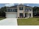 Charming two-story home featuring a brick and siding facade, an attached garage, and a well-manicured lawn at 3166 Morris Hills Dr, Dacula, GA 30019