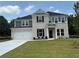 Charming two-story home featuring a brick and siding facade, an attached garage, and a well-manicured lawn at 3166 Morris Hills Dr, Dacula, GA 30019