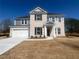 Charming two-story home with a brick facade, well-manicured lawn, and attached two-car garage at 3166 Morris Hills Dr, Dacula, GA 30019
