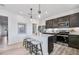 Modern kitchen with a quartz countertop island, stainless steel appliances, and dark wood cabinets at 3166 Morris Hills Dr, Dacula, GA 30019