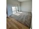 Open-concept living room featuring wood-look floors and cozy neutral carpet at 3166 Morris Hills Dr, Dacula, GA 30019