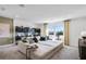 Spacious living room with a large sectional sofa, windows, and modern decor at 3166 Morris Hills Dr, Dacula, GA 30019
