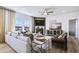 Cozy living room with large windows, hardwood floors, a fireplace, and a ceiling fan at 3166 Morris Hills Dr, Dacula, GA 30019