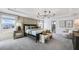 Well-lit main bedroom features luxury bed, carpeting, and adjacent bath at 3166 Morris Hills Dr, Dacula, GA 30019