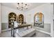 Stylish home office featuring custom bookshelves, decorative lighting, and a comfortable seating area at 3166 Morris Hills Dr, Dacula, GA 30019