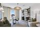 Cozy sitting room featuring a stylish light fixture, couch, and unique built-in shelving at 3166 Morris Hills Dr, Dacula, GA 30019
