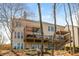 Spacious backyard with a tiered deck overlooking lush landscaping, ideal for relaxing and entertaining at 4240 Agard St, Cumming, GA 30040