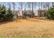 Large backyard with mature trees, providing privacy and shade, enhancing the outdoor experience at 4240 Agard St, Cumming, GA 30040