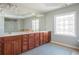 Bathroom with spacious double vanity, decorative window, tile floor, and modern fixtures at 4240 Agard St, Cumming, GA 30040