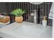 Modern bathroom sink with decorative plant, white countertop, and sleek black tile backsplash at 4240 Agard St, Cumming, GA 30040
