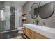 Modern bathroom featuring double sinks, sleek shower, wood paneling and stylish fixtures at 4240 Agard St, Cumming, GA 30040