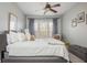 Bright bedroom features a ceiling fan, large window with curtains, and neutral colored walls at 4240 Agard St, Cumming, GA 30040