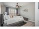 Bright bedroom features a ceiling fan, large window with curtains, and neutral colored walls at 4240 Agard St, Cumming, GA 30040