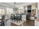 Bright dining area located adjacent to a modern living room and a kitchen at 4240 Agard St, Cumming, GA 30040