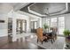 Spacious dining room with dark wood floors, large windows, stylish lighting, and direct access to foyer at 4240 Agard St, Cumming, GA 30040