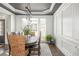 Beautiful dining room with dark wood floors, modern lighting, and white wainscoting along the walls at 4240 Agard St, Cumming, GA 30040