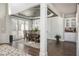 Elegant dining room with dark wood floors, a modern chandelier, and white wainscoting at 4240 Agard St, Cumming, GA 30040