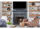 A cozy fireplace features beautiful marble, wooden shelves, and display decorations at 4240 Agard St, Cumming, GA 30040