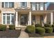 Inviting front porch with white columns and double doors, complemented by manicured landscaping at 4240 Agard St, Cumming, GA 30040