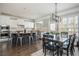 Eat-in kitchen with stainless steel appliances, island seating, and dining table by large windows at 4240 Agard St, Cumming, GA 30040