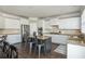 Bright kitchen with stainless steel appliances, granite counters and a center island with bar stool seating at 4240 Agard St, Cumming, GA 30040