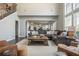 A large living room includes a high ceiling, large windows, stairs, and is open to the kitchen at 4240 Agard St, Cumming, GA 30040