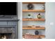 Wooden shelves display decorative items to highlight the fireplace and entertainment area at 4240 Agard St, Cumming, GA 30040