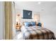 Comfortable bedroom with stylish decor, a plaid bedspread, and a functional desk setup at 227 Groveton Ct, Euharlee, GA 30145