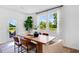 Sunlit dining area featuring a wooden table, modern chairs, and backyard views at 227 Groveton Ct, Euharlee, GA 30145