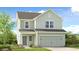 Charming two-story home with a gray exterior, attached two-car garage, and a beautifully landscaped front yard at 227 Groveton Ct, Euharlee, GA 30145