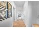 Bright hallway with modern art and wood floors provides an open and airy transition space at 227 Groveton Ct, Euharlee, GA 30145