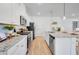 Modern white kitchen boasting stainless steel appliances, granite countertops, and ample cabinet space at 227 Groveton Ct, Euharlee, GA 30145