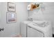 Convenient laundry room featuring a washer, dryer, and shelving for storage, making laundry days a breeze at 227 Groveton Ct, Euharlee, GA 30145