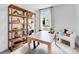Bright and airy home office with a wooden desk, shelving, and a comfortable chair, ideal for remote work at 227 Groveton Ct, Euharlee, GA 30145