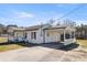 A single-story home featuring a white exterior and a convenient covered parking area at 3384 Nebo Rd, Dallas, GA 30157