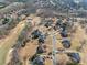 This is an aerial view of the community featuring golf course, tree coverage, landscaping, and winding roads at 408 Hickory Fairway Ct, Woodstock, GA 30188