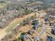 This aerial image displays stunning community homes alongside a well-manicured golf course and road at 408 Hickory Fairway Ct, Woodstock, GA 30188