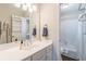 This bathroom features a white vanity, a large mirror and a view to the shower-tub combo at 408 Hickory Fairway Ct, Woodstock, GA 30188