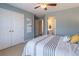 Bedroom features a closet, ceiling fan, and view to the ensuite bathroom at 408 Hickory Fairway Ct, Woodstock, GA 30188