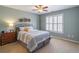 This is a spacious bedroom with a large window, plantation shutters, and neutral decor at 408 Hickory Fairway Ct, Woodstock, GA 30188
