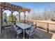 Deck with seating and a wooden pergola overlooking the expansive backyard at 408 Hickory Fairway Ct, Woodstock, GA 30188